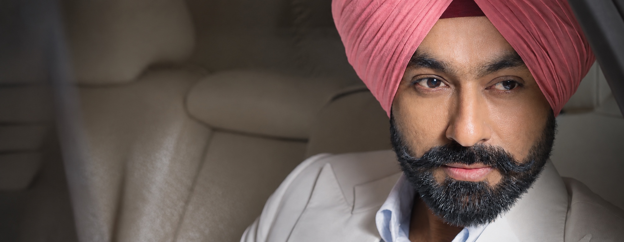 Tarsem Jassar wearing a pink turban